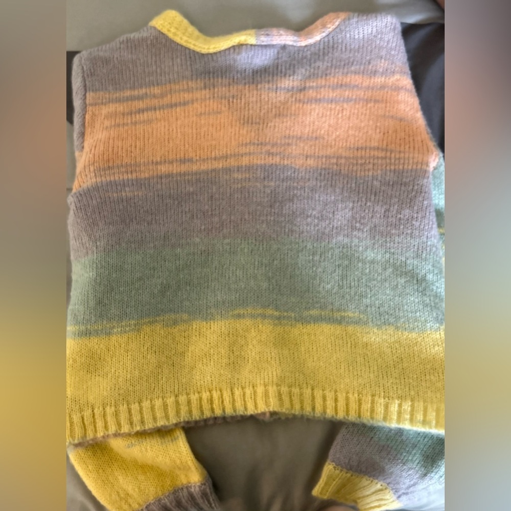This sweater is from Tilly’s the Brand is RSQ. It is multicolored. Juniors XL.